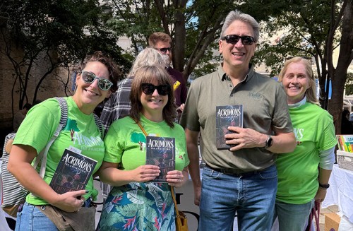 Harper College Community Education student Brian Gary (second from right) is a published author who recently celebrated his debut children's novel at Printer's Row Lit Fest. Members of his writing class cohort showed up in support of their classmate, wearing custom T-shirts that promoted his book.