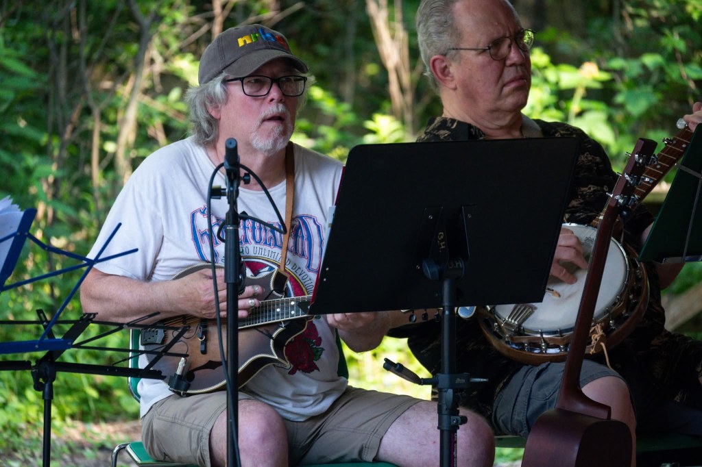 Singer and banjo player in the Back Porch Revue playing at the Spring Valley Nature Center, June 2025