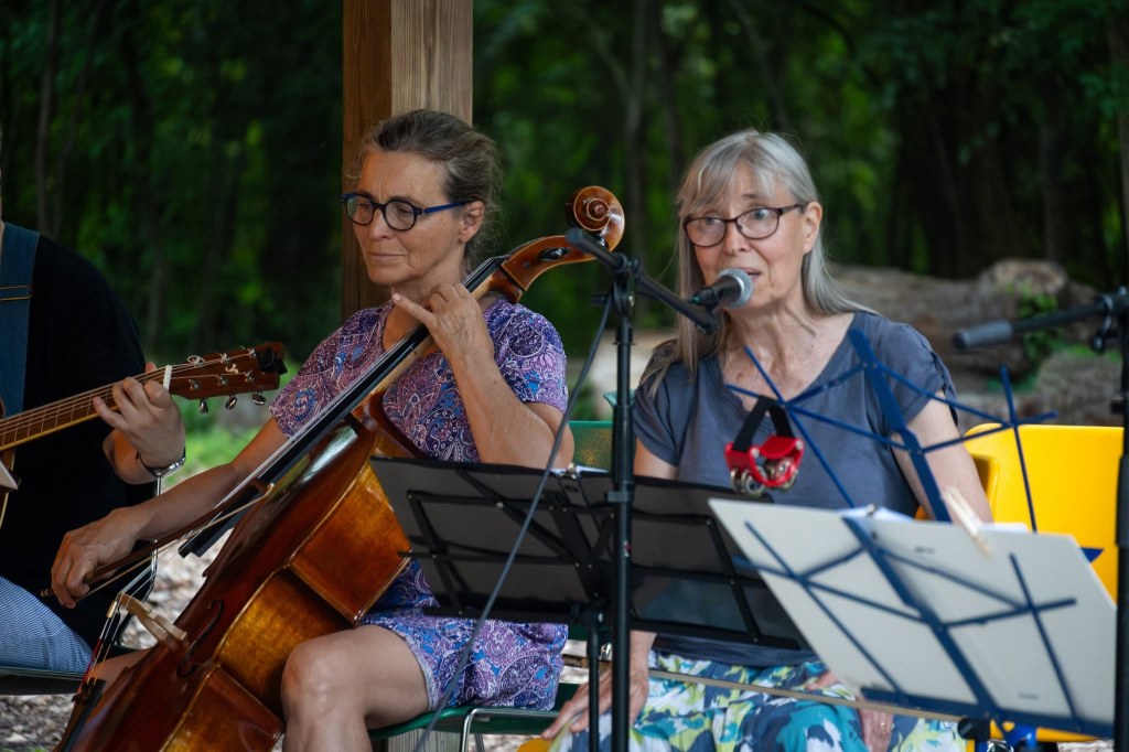 Bev Riley playing cello and Linda Foltz singing with the Back Porch Revue at the Spring Valley Nature Center, June 2025