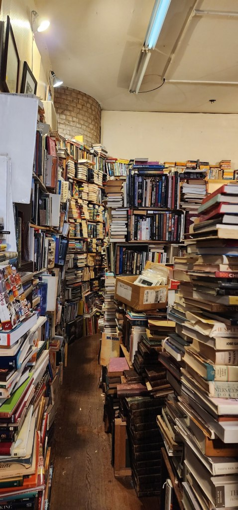 Photo of a bookstore in New Orleans crammed with books.