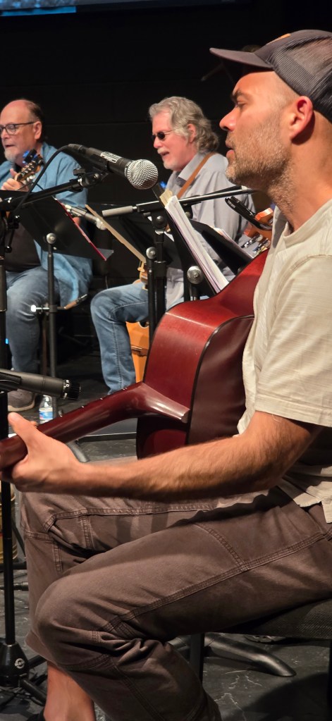 Photo of the Back Porch Revue performing in May 2026 with co-leader Bekr Ali in the foreground.